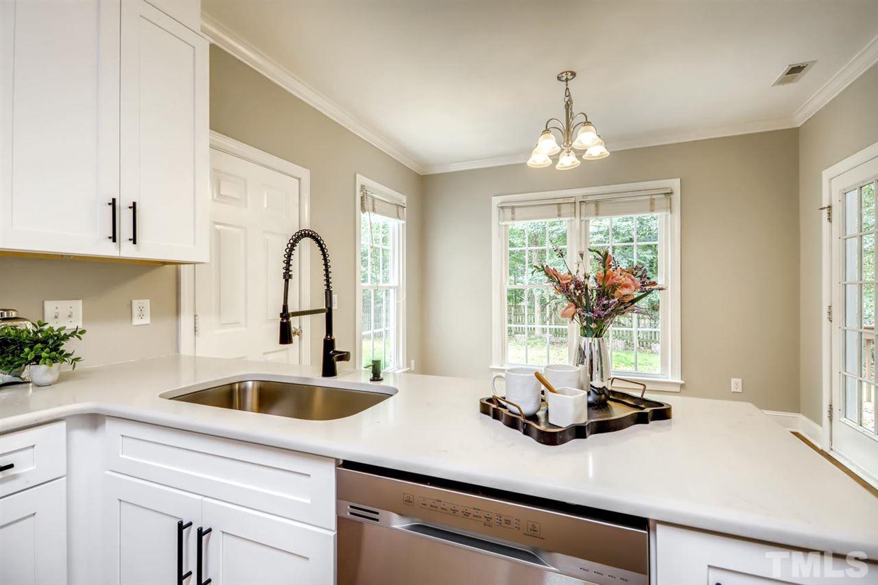 5205 Covington Bend Drive Raleigh, NC 27613 - Photo 2 of 16 Another view of the kitchen, tons of counter & cabinet space! Don't miss the large cabinet that's accessed from the back side of the cabinets by the back door.