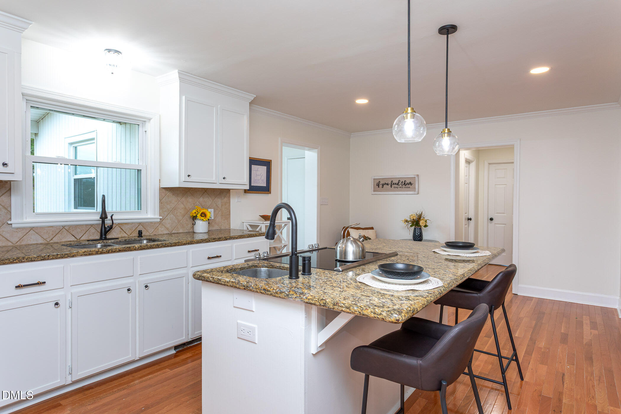 641 Rocky Ford Road Louisburg, NC 27549 - Photo 10 of 40 a kitchen with kitchen island granite countertop a sink a center island and cabinets