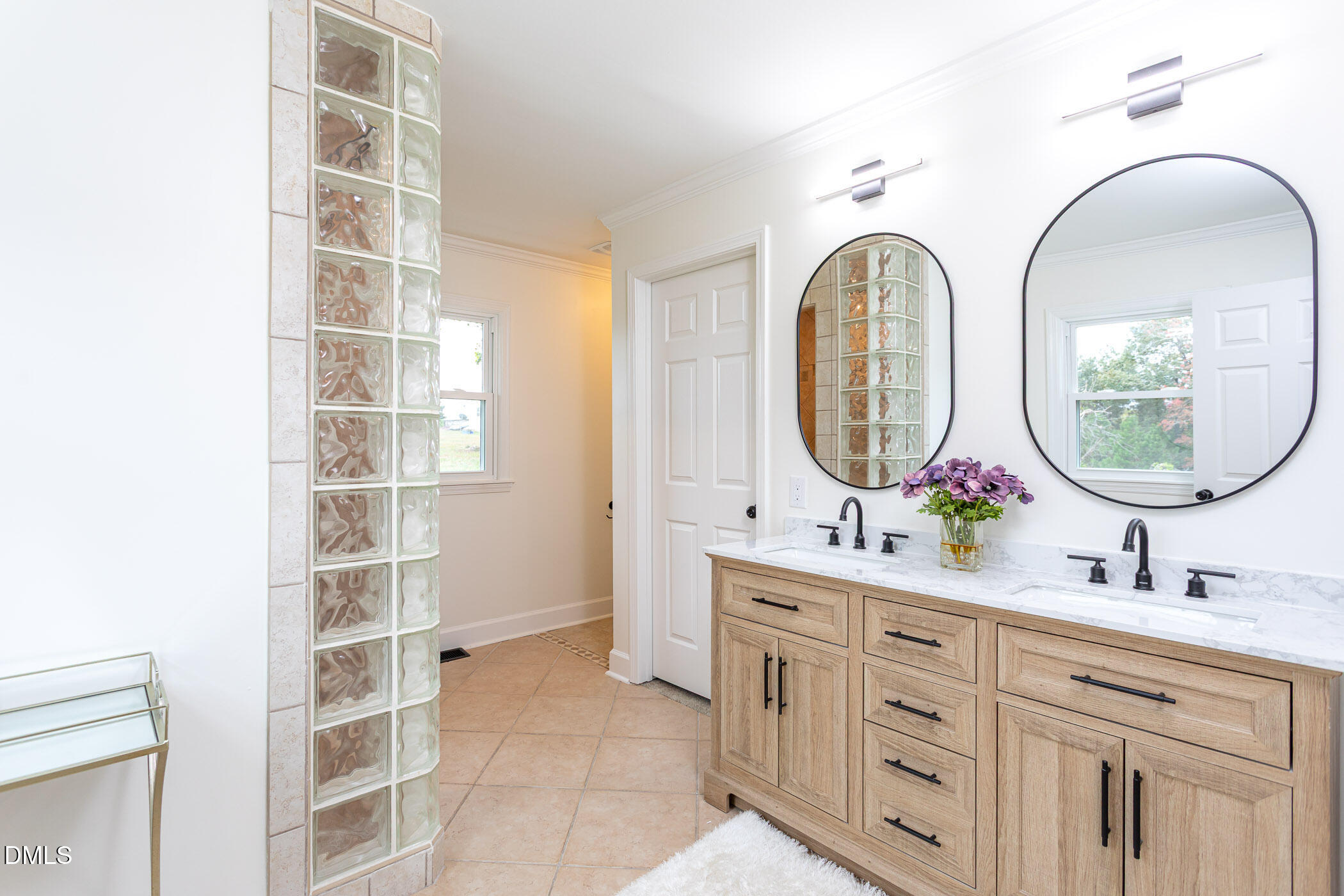641 Rocky Ford Road Louisburg, NC 27549 - Photo 17 of 40 a bathroom with a double vanity sink a mirror and a shower