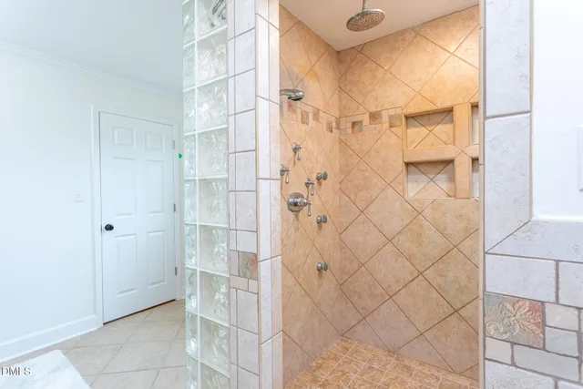 a bathroom with a white shower and a shower curtain