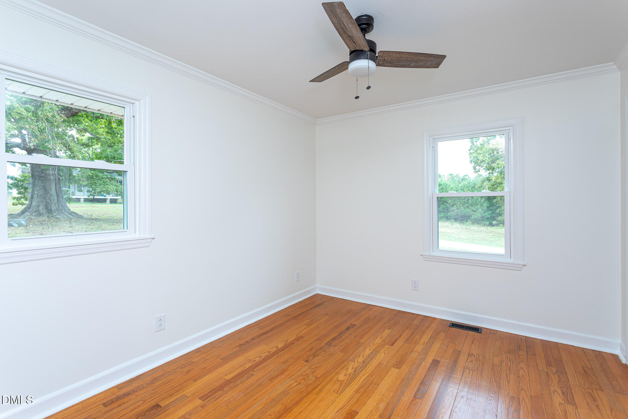 641 Rocky Ford Road Louisburg, NC 27549 - Photo 22 of 40 a view of empty room with wooden floor and fan