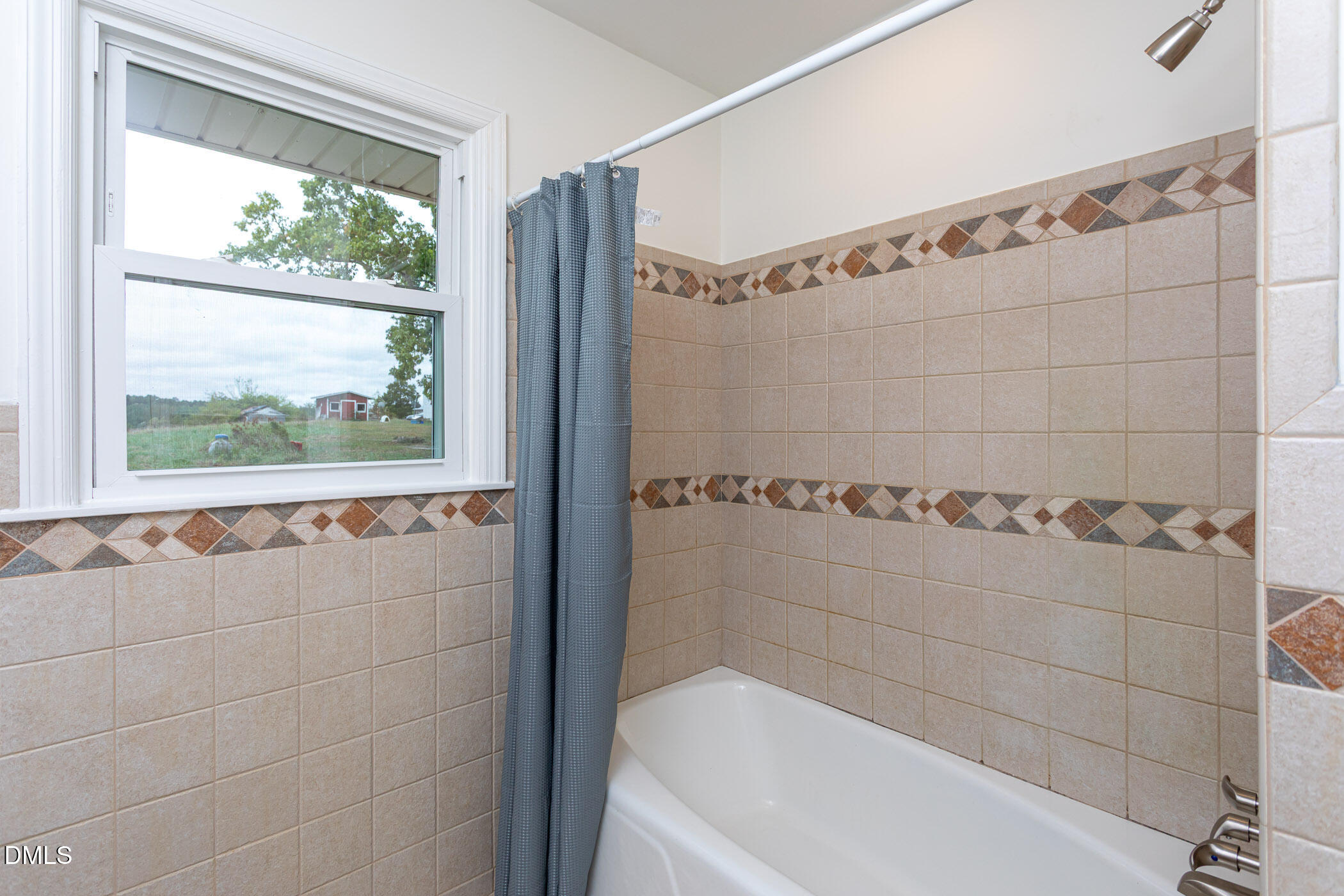 641 Rocky Ford Road Louisburg, NC 27549 - Photo 29 of 40 a bathroom with a bathtub and a shower