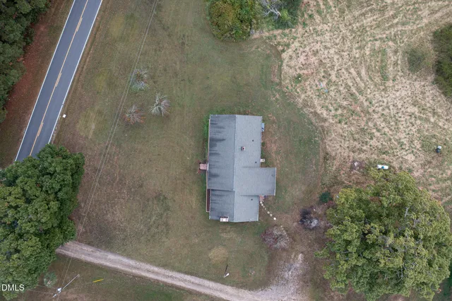 an aerial view of a house with a yard