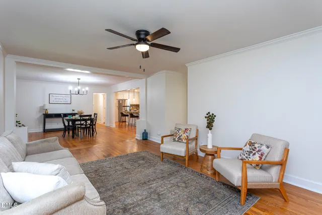 a living room with furniture and a dining table with kitchen view