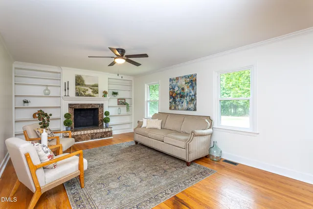 a living room with furniture a window and a fireplace