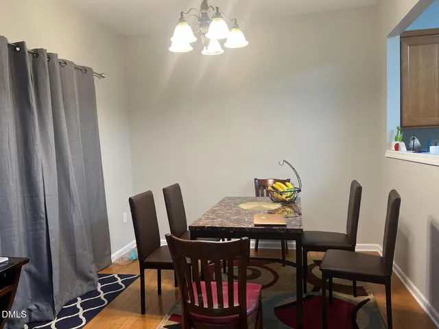 a view of a dining room with furniture and chandelier