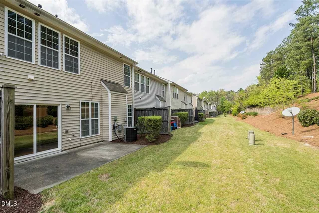 a view of a house with a yard and garage