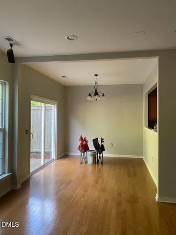 a view of a room with wooden floor and windows