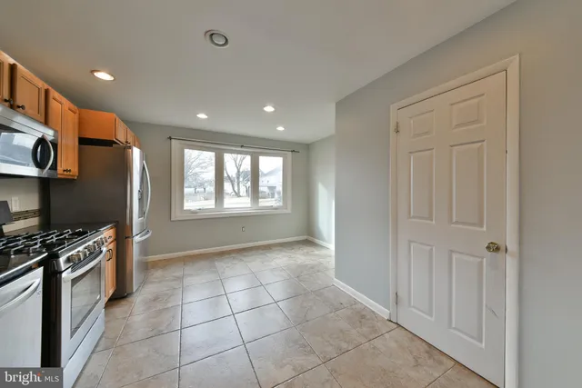 a view of a kitchen with an empty space and workspace