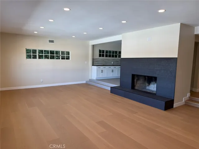 a view of an empty room with a fireplace