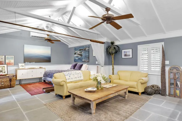 a bedroom with a bed and a large window with outer view