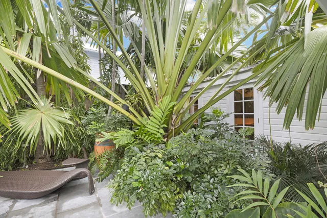 a view of a house with swimming pool next to a yard