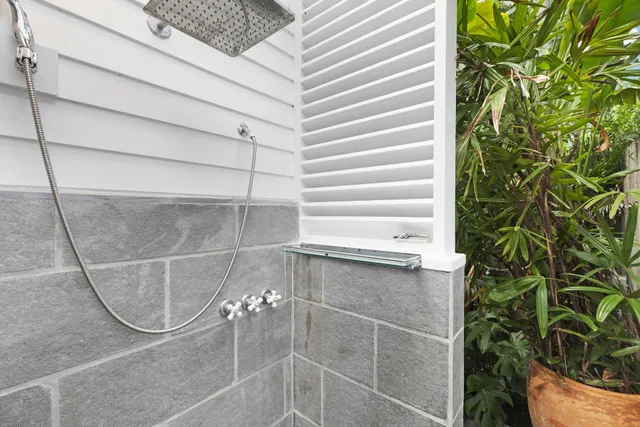 a view of a house with swimming pool next to a yard