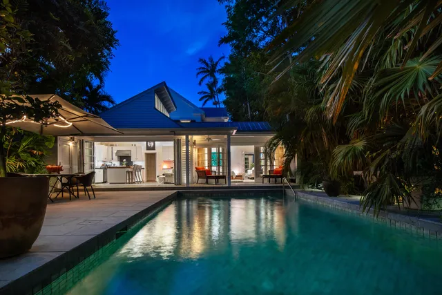a living room with furniture a flat screen tv and floor to ceiling window