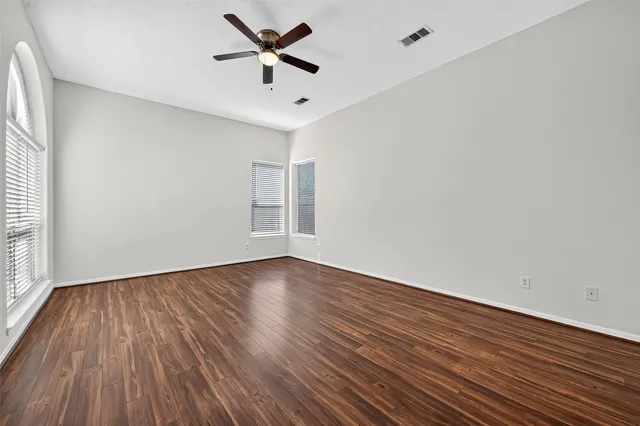 wooden floor in an empty room with a window