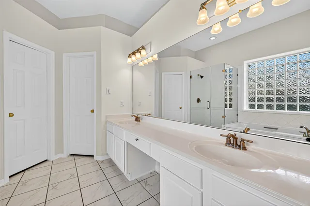 a bathroom with a bathtub and next to a window