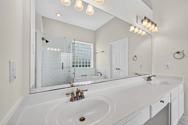 a spacious bathroom with a tub shower and a sink
