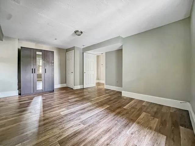 a view of an empty room and wooden floor