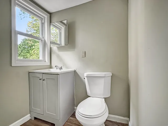 a white toilet sitting next to a bathroom sink