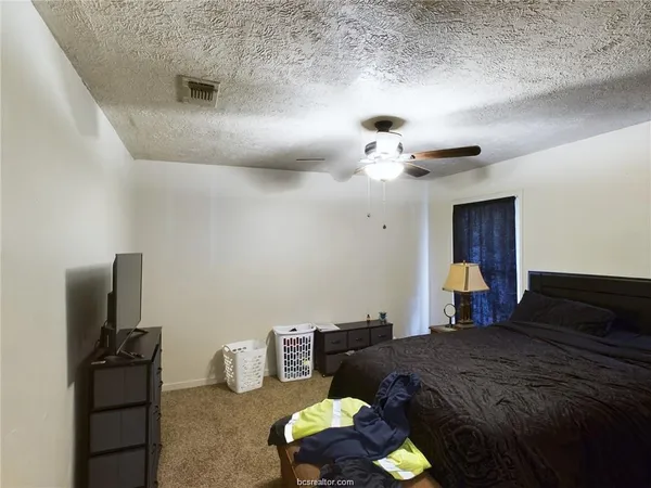 a bedroom with furniture and a chandelier