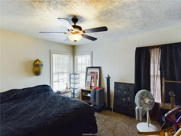 a bedroom with a bed and dresser