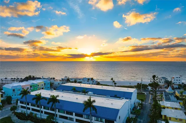 a view of a terrace with lawn chairs