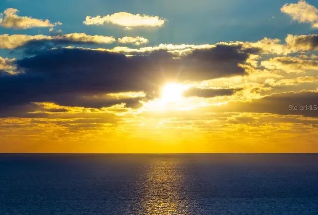 an aerial view of a house with a yard and lake view