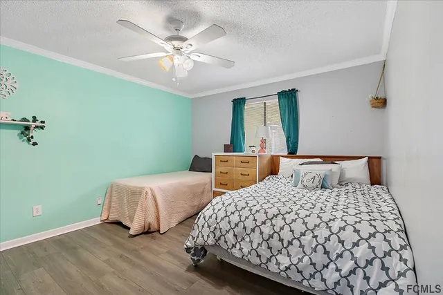 a bedroom with two beds and a chandelier