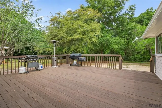 a balcony with view of trees in the background
