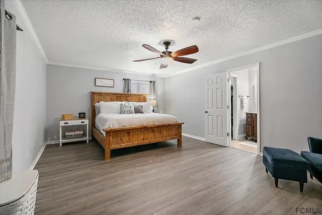 a bedroom with a bed and a chair