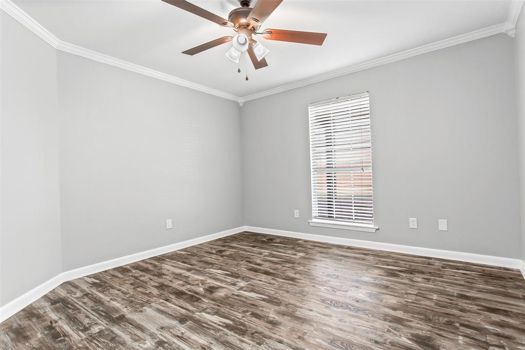 712 Billups Street Van Alstyne, TX 75495 - Photo 33 of 38 a view of a room with a ceiling fan and wooden floor