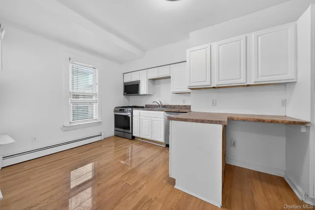 a kitchen with granite countertop a stove and a microwave