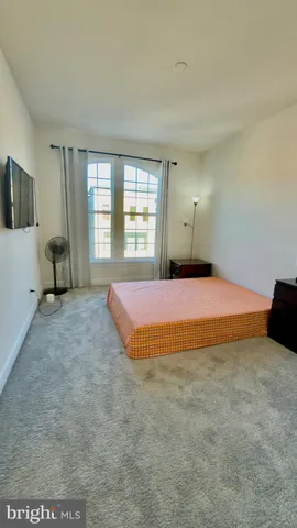 a spacious bedroom with a bed and a couch