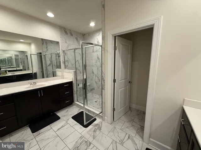 a bathroom with a double vanity sink toilet and shower