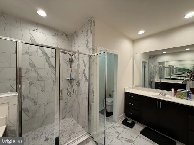a bathroom with a shower sink and mirror