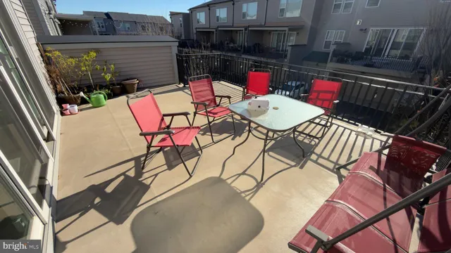 a backyard of a house with table and chairs