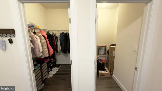 a view of walk in closet with clothes