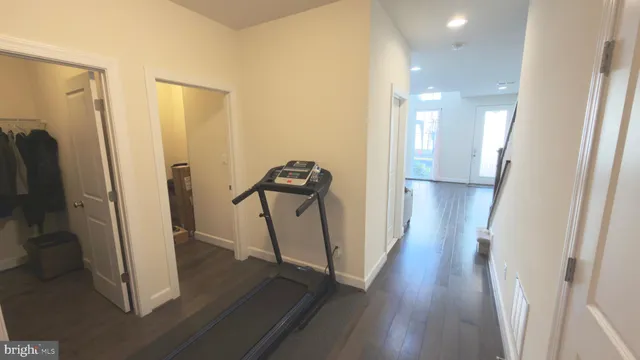 a view of a hallway with wooden floor and staircase