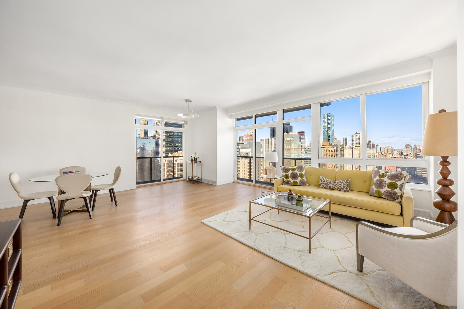 100 United Nations Plaza, Unit 35E Manhattan, NY 10017 - Photo 2 of 11 a living room with furniture and a table