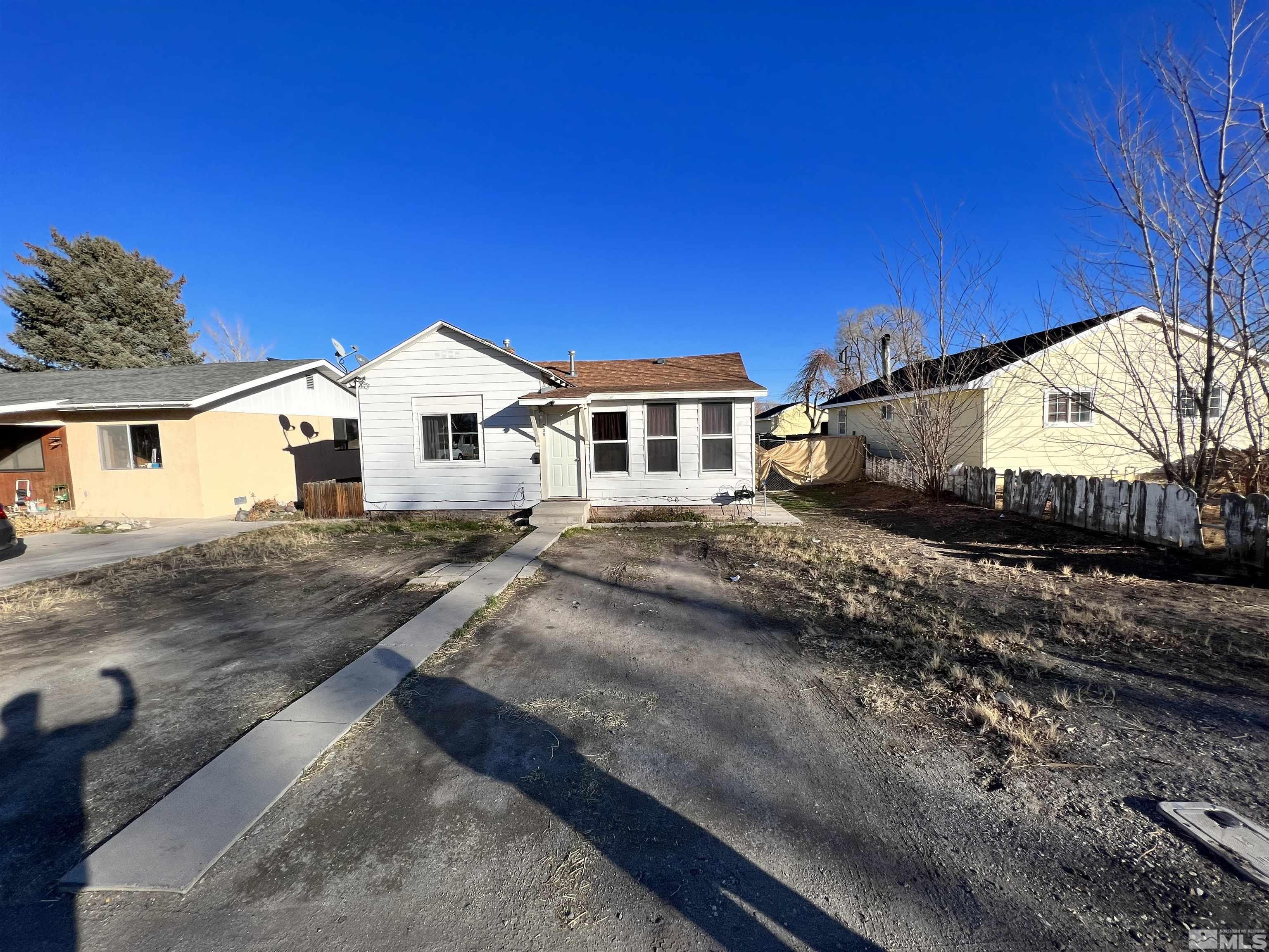 220 South Nevada Street, Unit 3 Yerington, NV 89447 - Photo 27 of 39 a view of a large white house with a yard and large trees