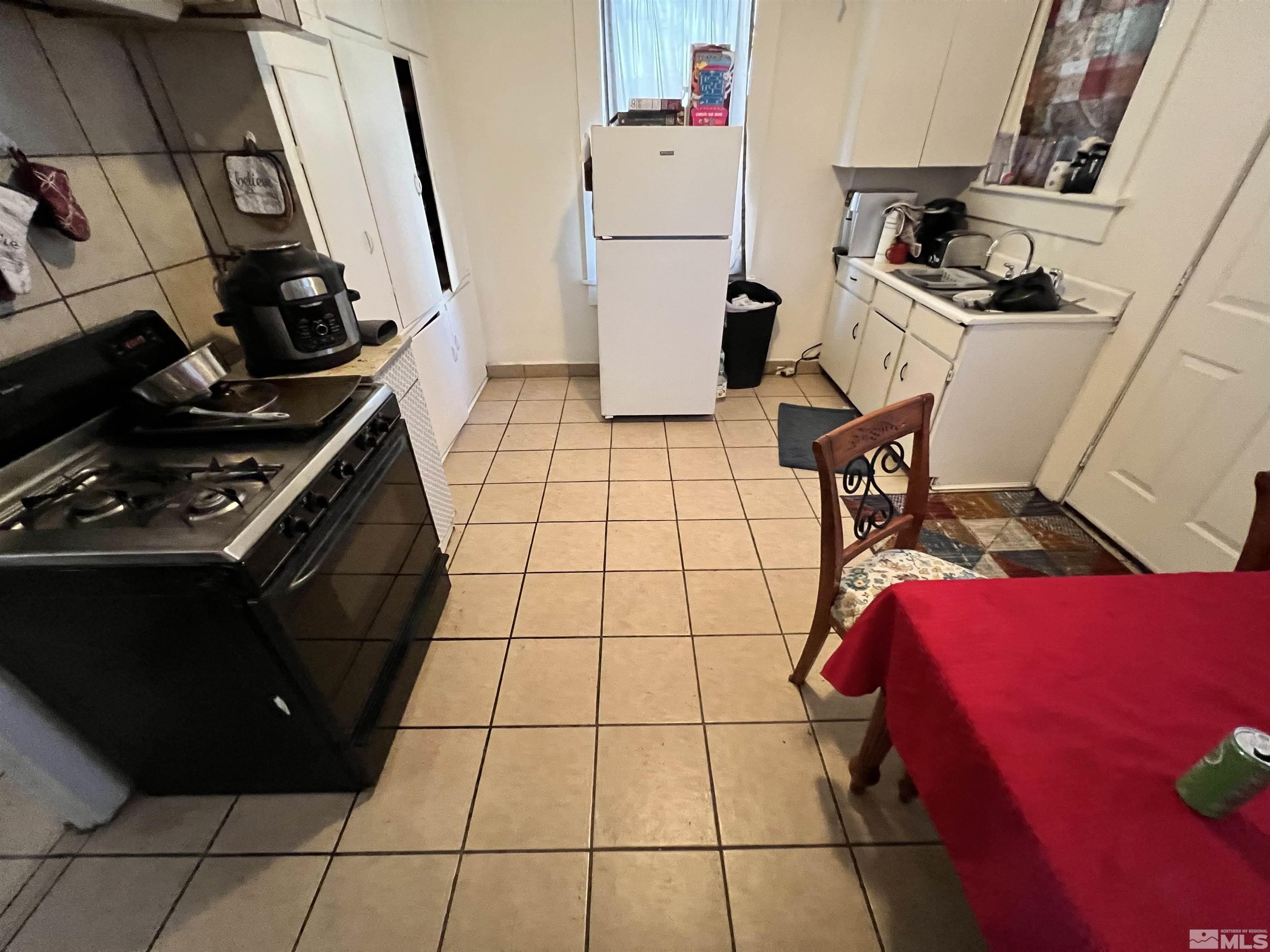 220 South Nevada Street, Unit 3 Yerington, NV 89447 - Photo 30 of 39 a kitchen with a stove and a refrigerator