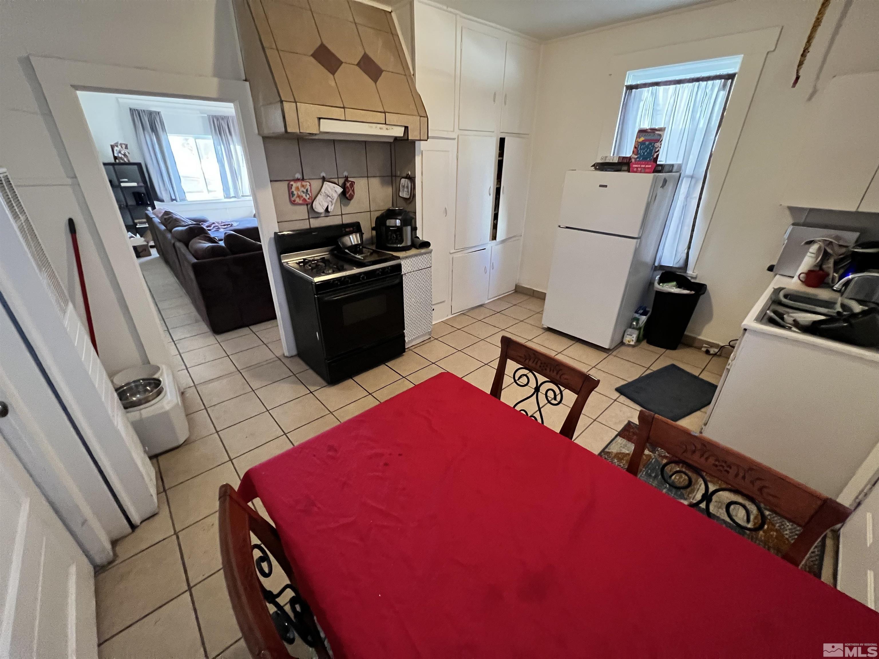 220 South Nevada Street, Unit 3 Yerington, NV 89447 - Photo 32 of 39 a kitchen with stainless steel appliances kitchen island granite countertop a refrigerator stove and sink