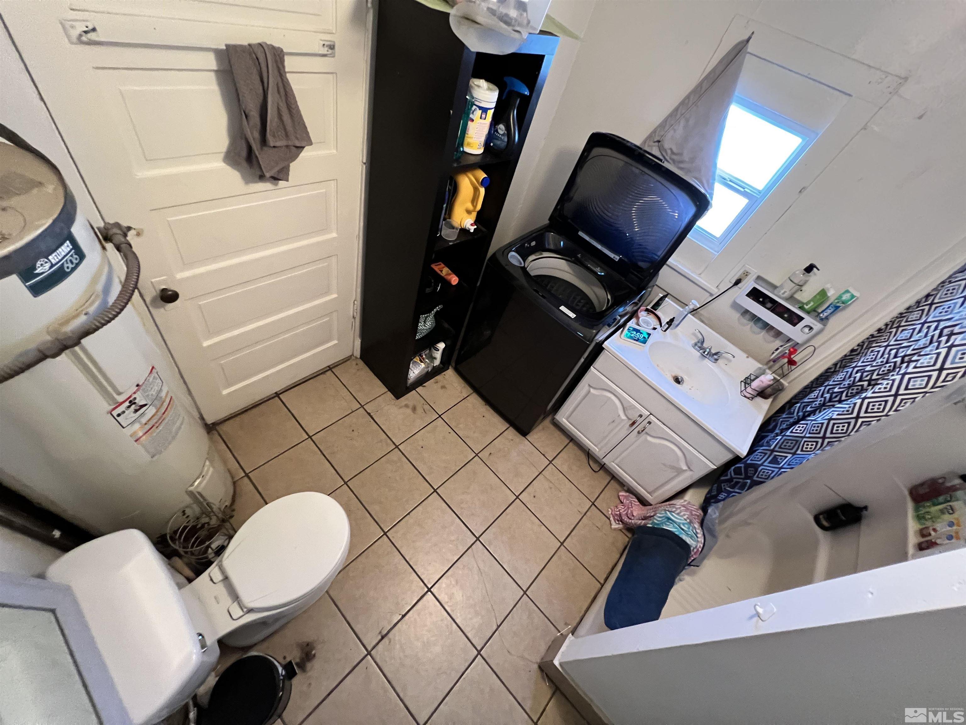 220 South Nevada Street, Unit 3 Yerington, NV 89447 - Photo 33 of 39 a bathroom with a sink mirror and vanity