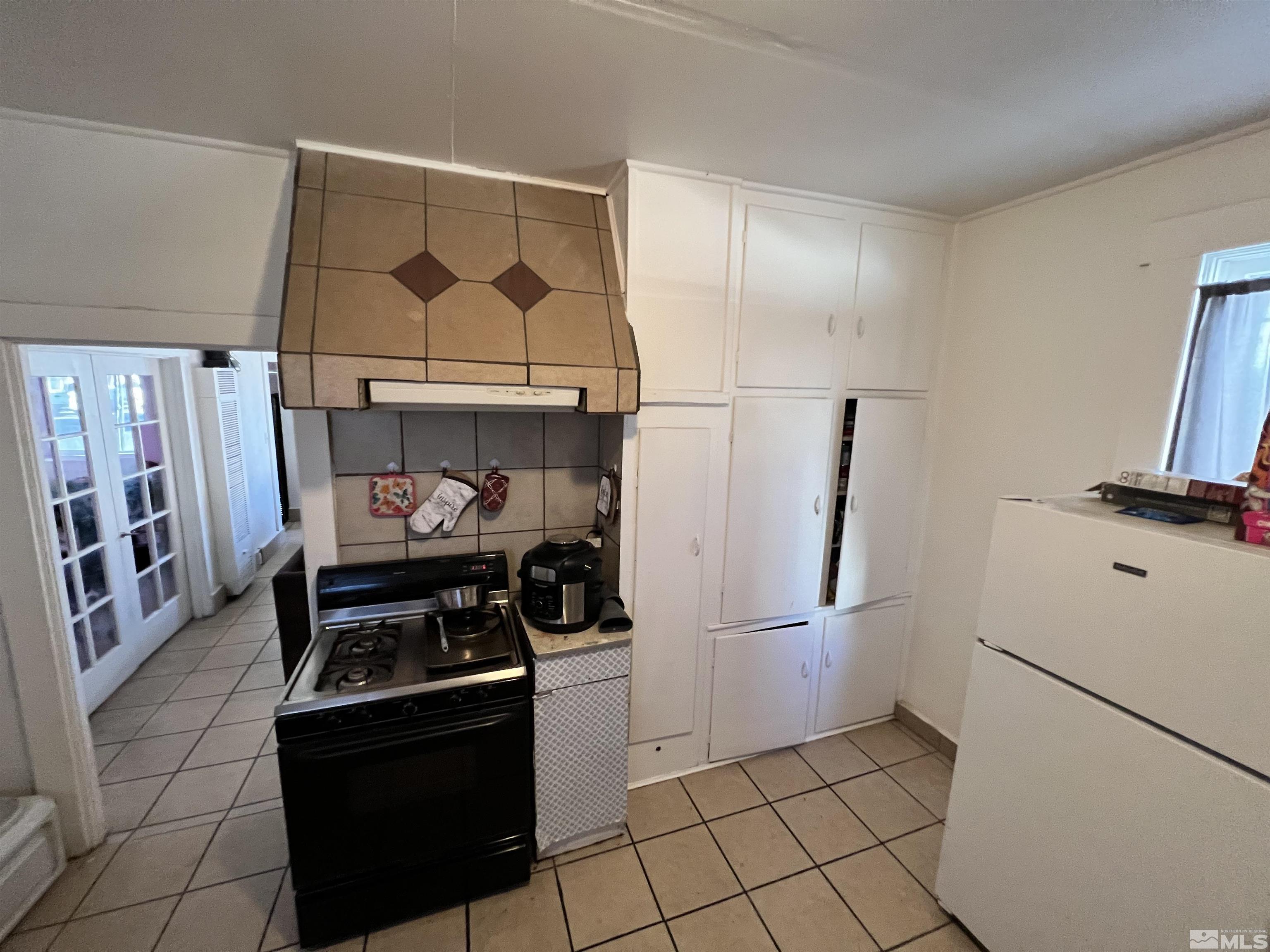 220 South Nevada Street, Unit 3 Yerington, NV 89447 - Photo 6 of 39 a kitchen with stainless steel appliances granite countertop a refrigerator and a stove top oven