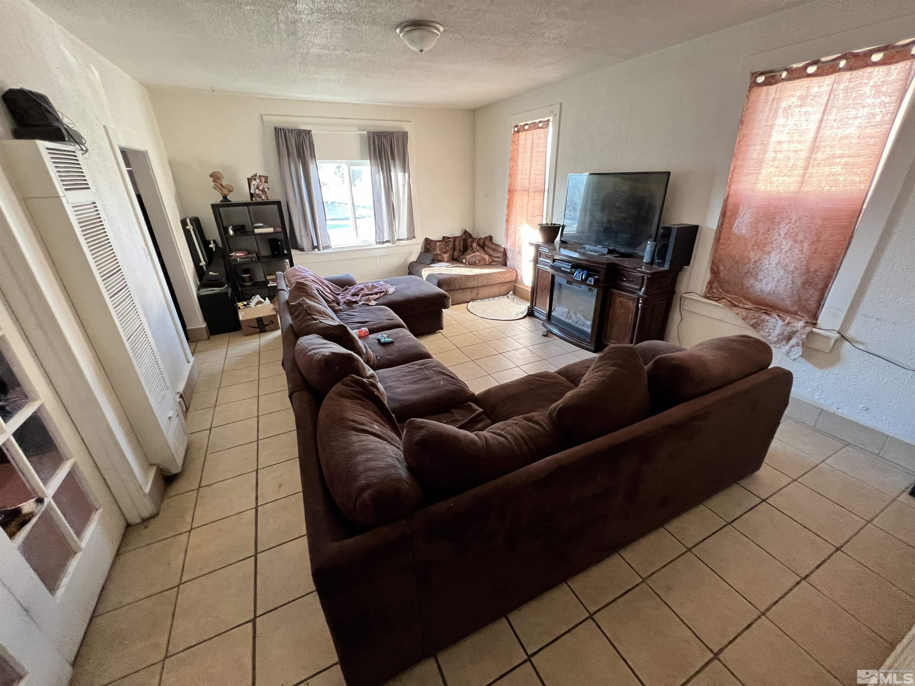 220 South Nevada Street, Unit 3 Yerington, NV 89447 - Photo 8 of 39 a living room with furniture and a flat screen tv