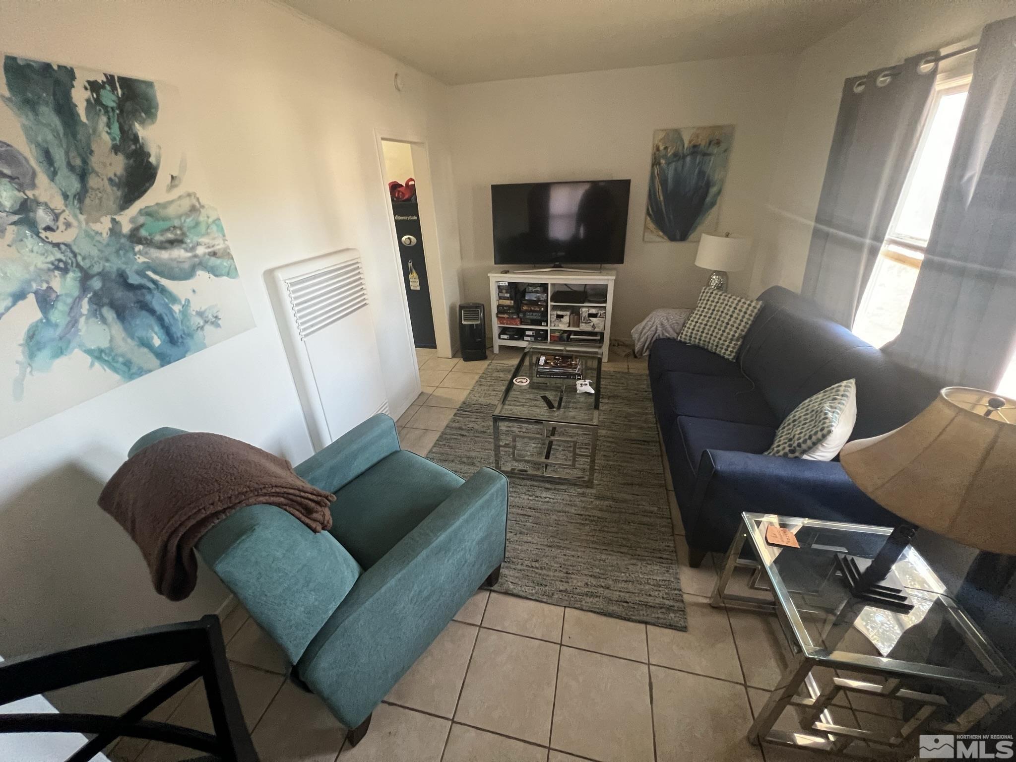 220 South Nevada Street, Unit 3 Yerington, NV 89447 - Photo 9 of 39 a living room with furniture and a flat screen tv