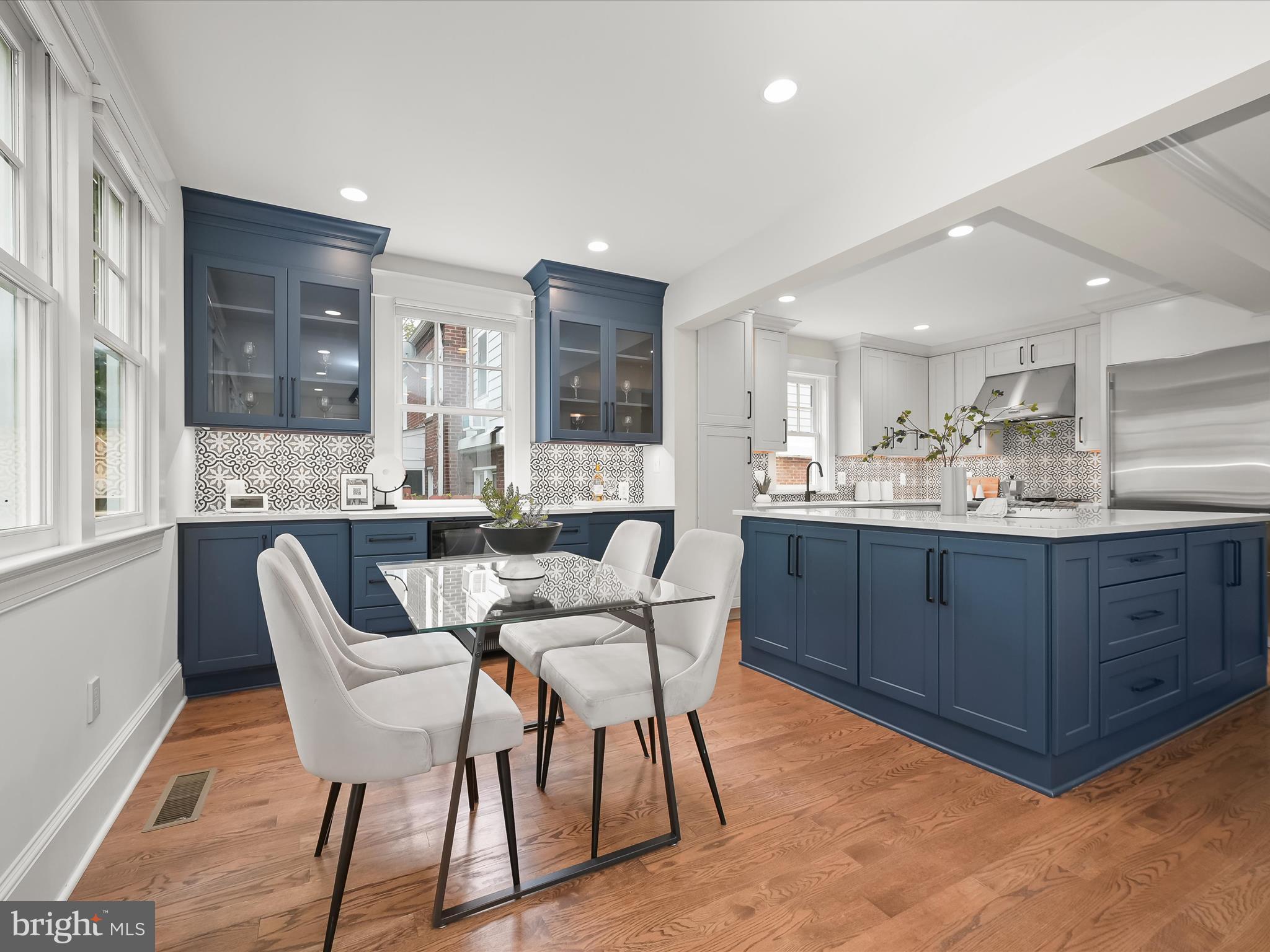 3118 17th Street North Arlington, VA 22201 - Photo 27 of 96 a kitchen with stainless steel appliances kitchen island granite countertop a sink a stove a dining table and chairs