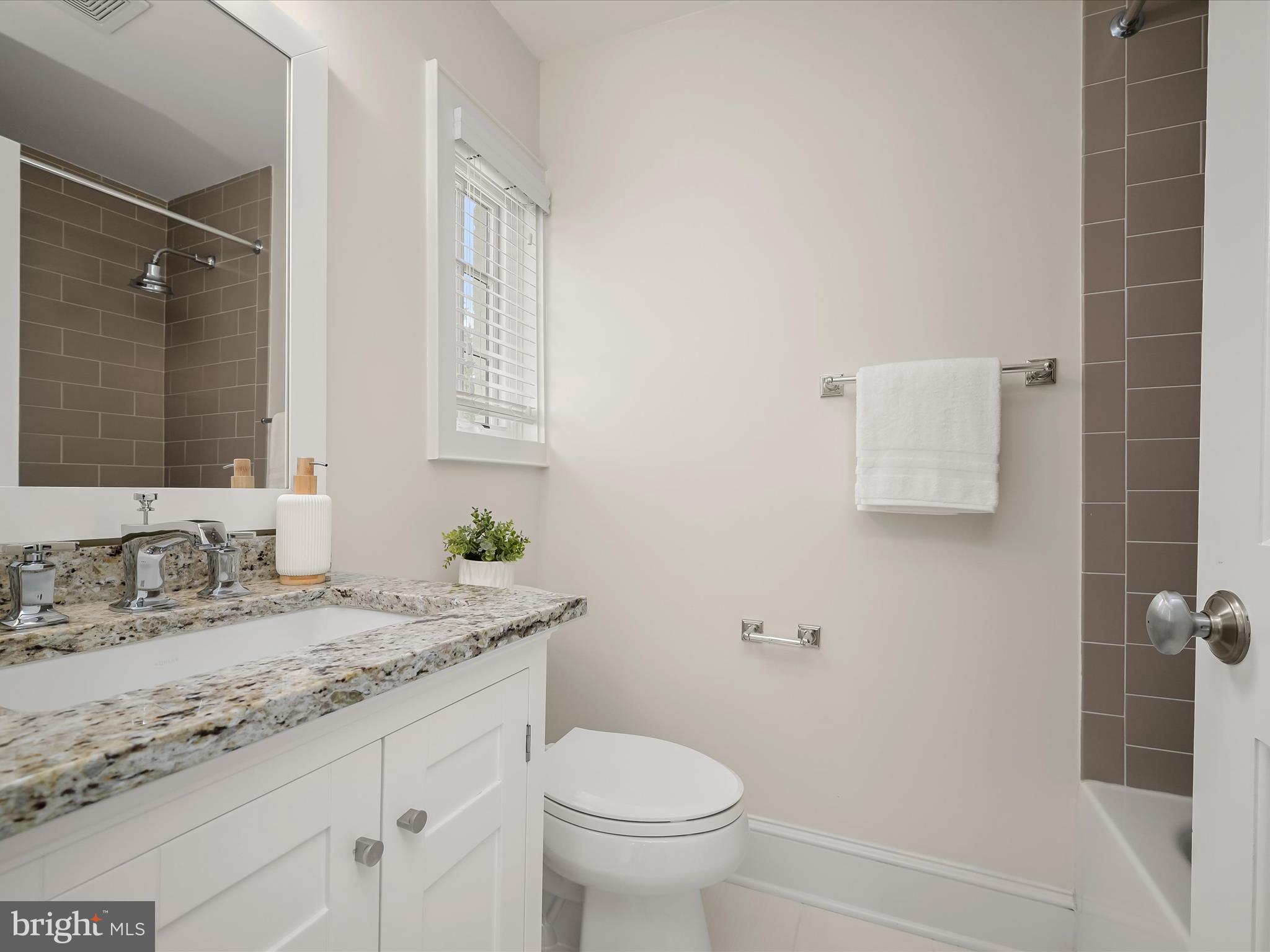 3118 17th Street North Arlington, VA 22201 - Photo 48 of 96 a bathroom with a granite countertop sink toilet and shower