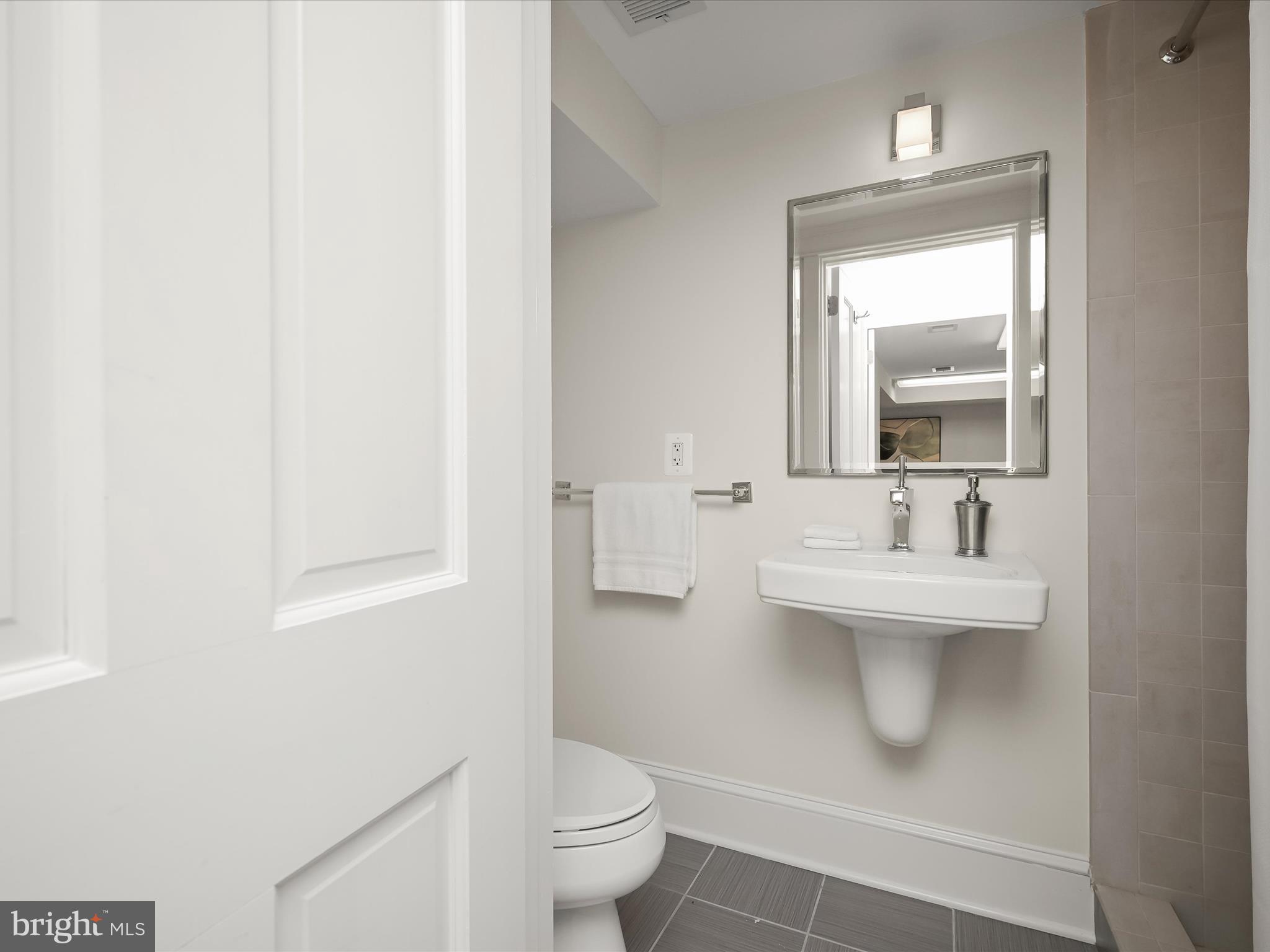 3118 17th Street North Arlington, VA 22201 - Photo 64 of 96 a bathroom with a toilet sink and mirror