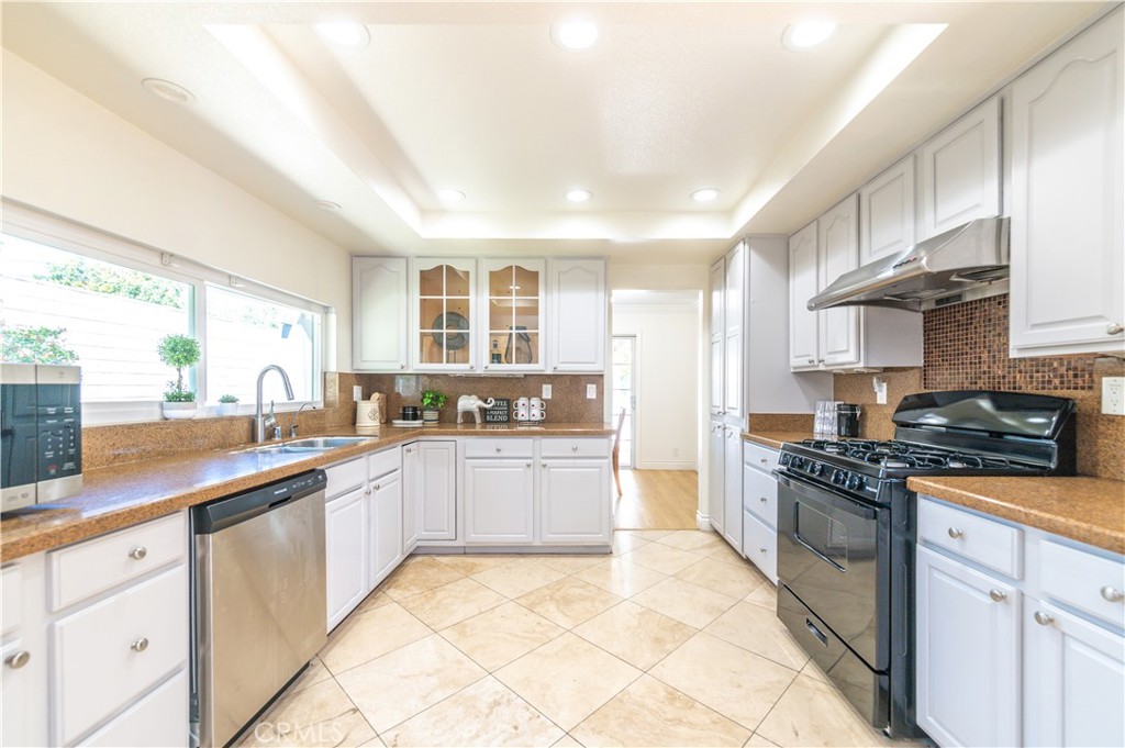 23711 Silver Spray Drive Diamond Bar, CA 91765 - Photo 19 of 49 a kitchen with stainless steel appliances granite countertop a stove a sink dishwasher and a refrigerator